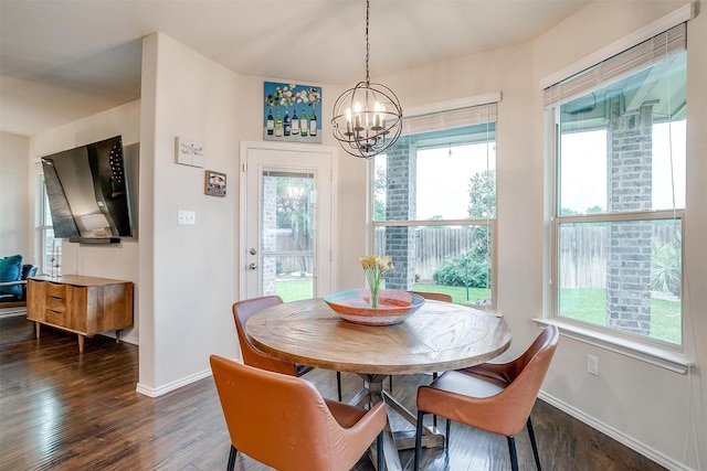 dining area featuring baseboards, dark wood-style flooring, and a notable chandelier