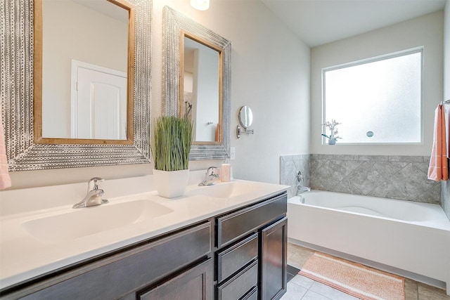 bathroom with double vanity, a sink, a bath, and tile patterned flooring