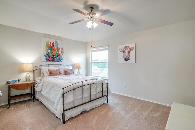 bedroom with baseboards, ceiling fan, and light colored carpet