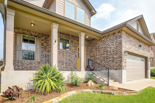 entrance to property featuring covered porch and brick siding