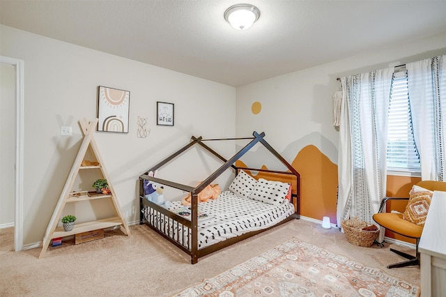 bedroom with carpet floors and baseboards