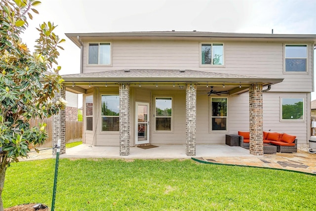 back of house with a lawn, a ceiling fan, fence, and a patio