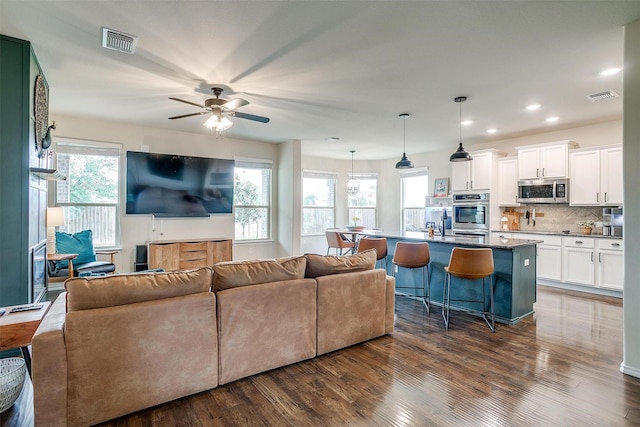 living room featuring visible vents, recessed lighting, dark wood finished floors, and ceiling fan