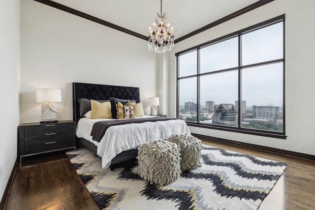 bedroom featuring crown molding, dark wood-style flooring, a notable chandelier, and multiple windows