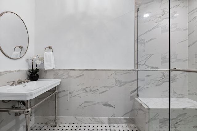 full bathroom with a marble finish shower