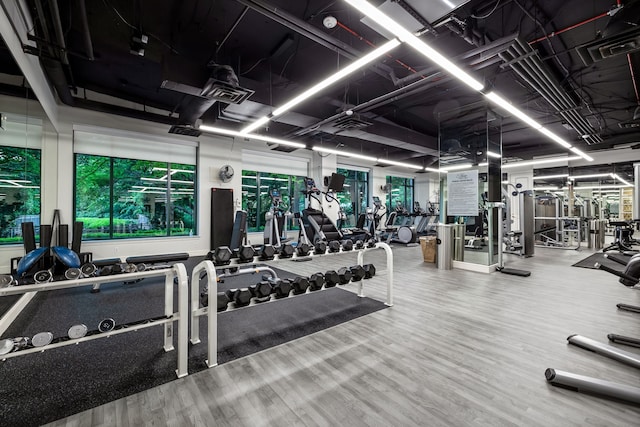 exercise room with visible vents and wood finished floors