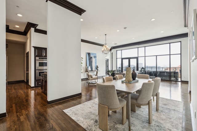 dining room featuring crown molding, baseboards, an inviting chandelier, and wood finished floors