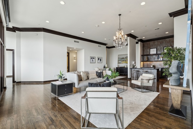 living room with visible vents, wood finished floors, a chandelier, ornamental molding, and recessed lighting