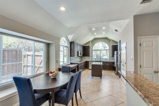 dining space with recessed lighting, vaulted ceiling, light tile patterned floors, and visible vents
