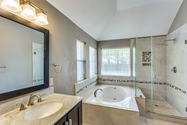 bathroom with a garden tub, vanity, a textured wall, lofted ceiling, and a stall shower