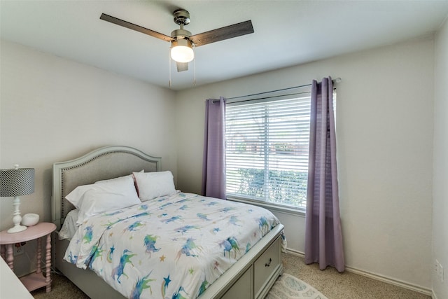 bedroom featuring a ceiling fan, baseboards, and light carpet