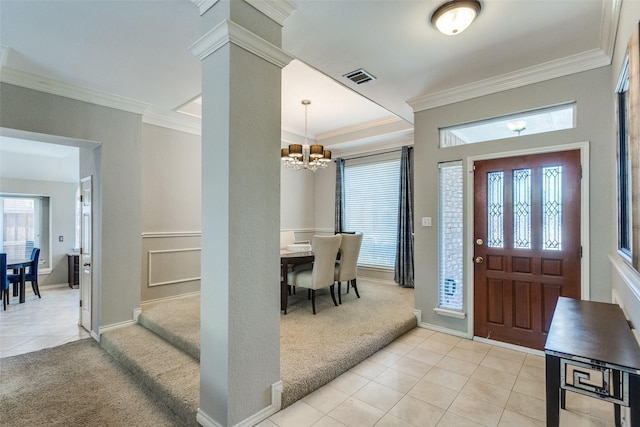 foyer entrance featuring crown molding, visible vents, light colored carpet, a chandelier, and light tile patterned floors