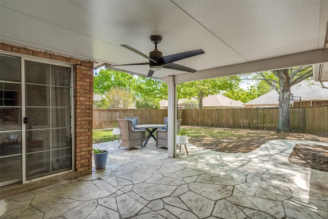 view of patio with ceiling fan, outdoor dining space, and a fenced backyard