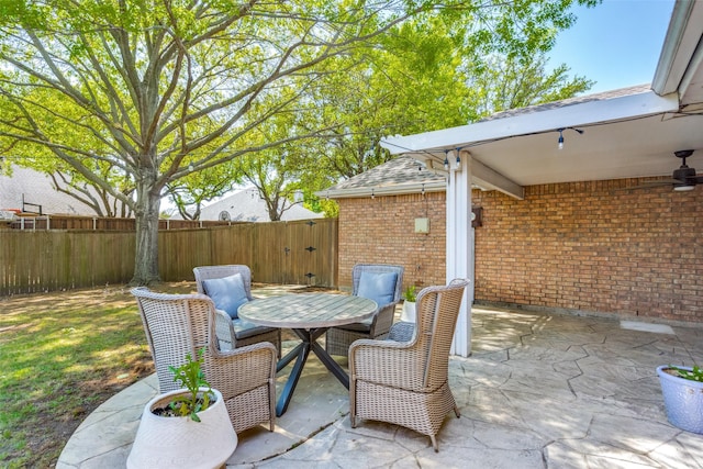 view of patio / terrace featuring a fenced backyard, ceiling fan, and outdoor dining space