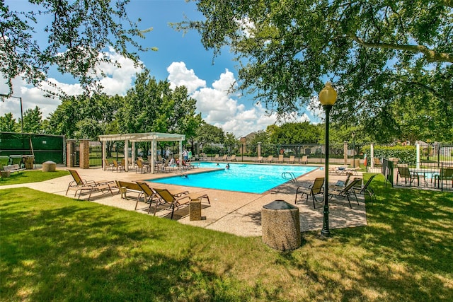 pool with a lawn, fence, and a patio