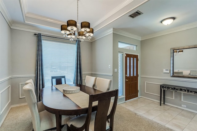 dining area with visible vents, ornamental molding, a notable chandelier, and a wealth of natural light