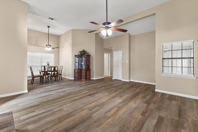 living area featuring baseboards, ceiling fan, wood finished floors, and visible vents