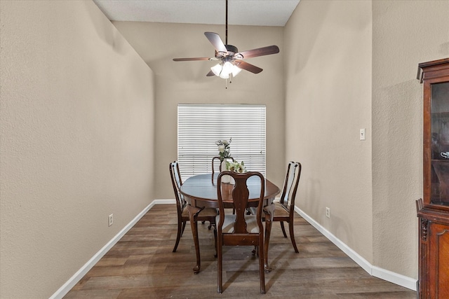 dining space featuring baseboards, ceiling fan, and wood finished floors