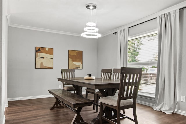 dining space featuring crown molding, dark wood-style flooring, baseboards, and an inviting chandelier