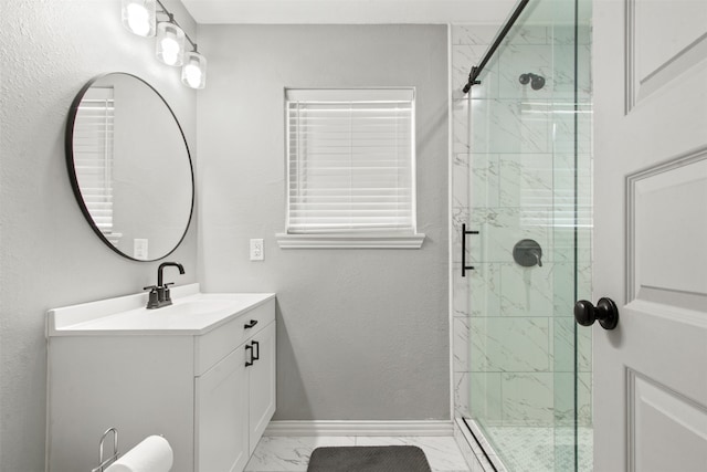 bathroom featuring a marble finish shower, baseboards, vanity, and marble finish floor