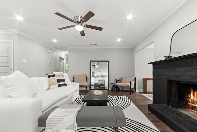 living area featuring ceiling fan, a fireplace, recessed lighting, and wood finished floors
