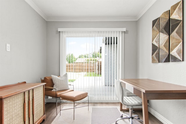 office space with crown molding, baseboards, and wood finished floors