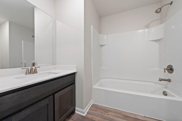 bathroom with  shower combination, wood finished floors, and vanity