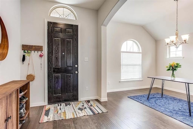 2704 Dancing Flame Dr, Denton, TX 76201 - entrance foyer with wood finished floors, arched walkways, a chandelier, baseboards, and lofted ceiling