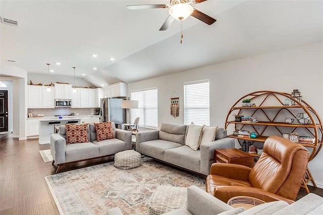2704 Dancing Flame Dr, Denton, TX 76201 - living area featuring vaulted ceiling, ceiling fan, wood finished floors, and recessed lighting