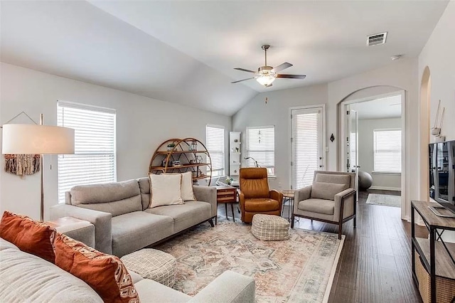 2704 Dancing Flame Dr, Denton, TX 76201 - living room featuring a ceiling fan, arched walkways, dark wood-type flooring, lofted ceiling, and baseboards