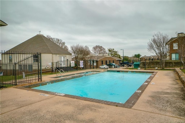 pool with fence and a patio area