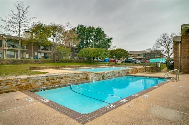 community pool with a jacuzzi