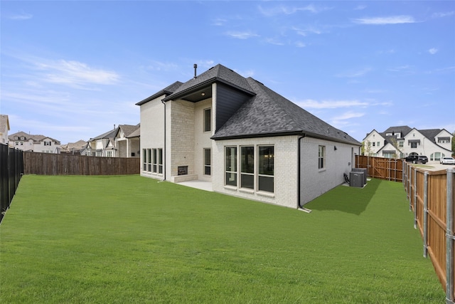 4524 Sky Harbor Dr, Rockwall, TX 75087 - rear view of property featuring roof with shingles, a residential view, brick siding, a fenced backyard, and a lawn
