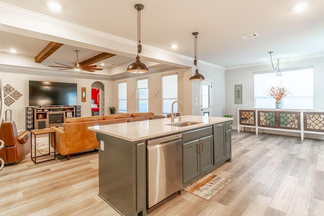 kitchen with visible vents, light countertops, a sink, light wood finished floors, and dishwasher