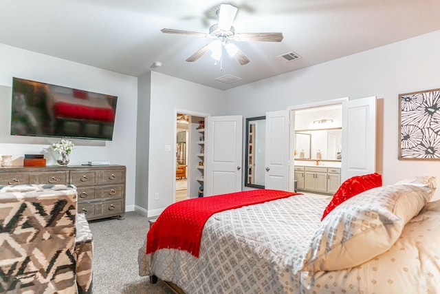 carpeted bedroom featuring baseboards, ensuite bathroom, a spacious closet, and visible vents