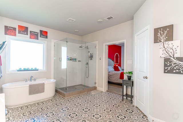 bathroom featuring visible vents, a stall shower, baseboards, and a freestanding bath