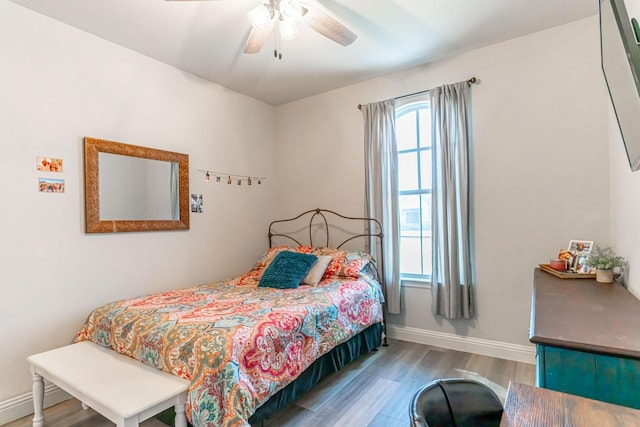 bedroom with baseboards, ceiling fan, and wood finished floors