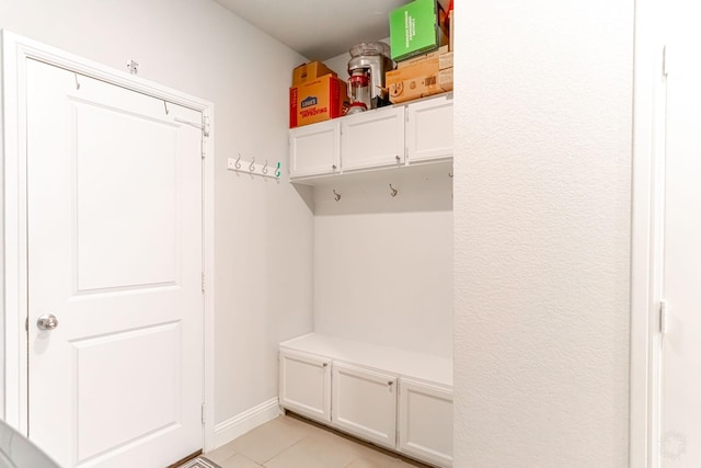 mudroom featuring baseboards and light tile patterned floors