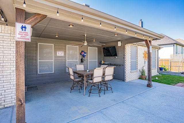 view of patio with fence, outdoor dining space, and ceiling fan