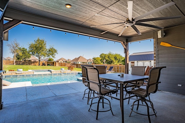 view of patio / terrace featuring a fenced backyard, a ceiling fan, a fenced in pool, and outdoor dining area