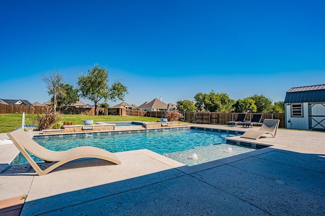 view of swimming pool with a fenced backyard, a patio area, and a storage unit