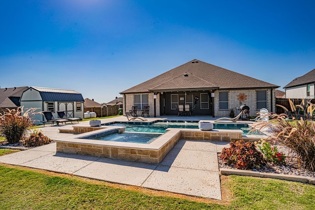 view of pool with a fenced in pool, an in ground hot tub, a patio area, and a fenced backyard