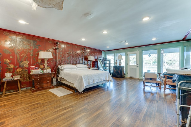 bedroom with visible vents, wood finished floors, ornamental molding, access to outside, and recessed lighting