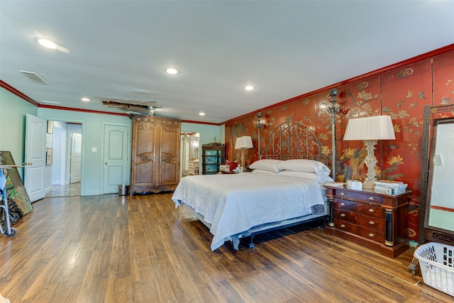 bedroom featuring crown molding, recessed lighting, visible vents, and wood finished floors