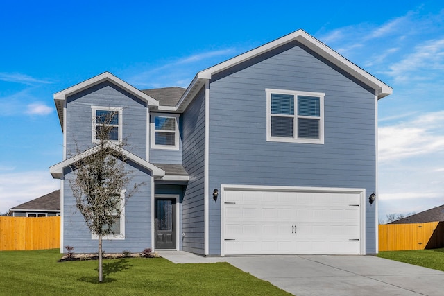 traditional-style house with concrete driveway, an attached garage, fence, and a front lawn