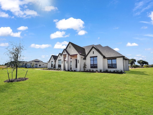 view of front of home with stucco siding and a front yard
