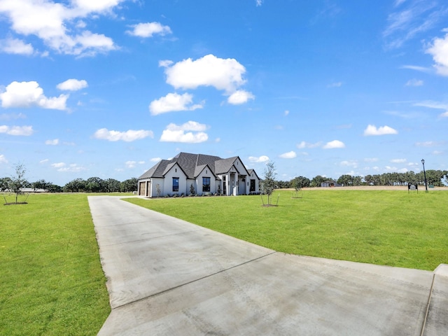 view of front of home with a front yard and concrete driveway