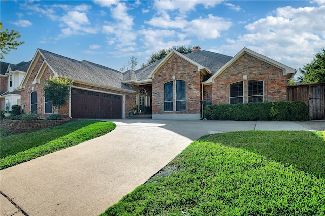 view of front of house featuring brick siding, a garage, fence, and driveway