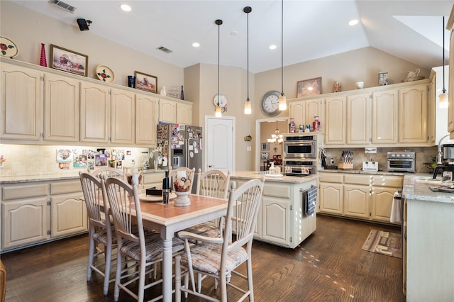 kitchen featuring visible vents, a kitchen island, dark wood-style floors, backsplash, and stainless steel appliances