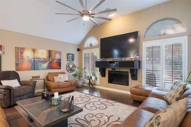 living room with baseboards, ceiling fan, a glass covered fireplace, and wood finished floors